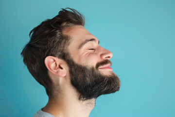 Obraz premium A close up of a man with beard and closed eyes looking to a side