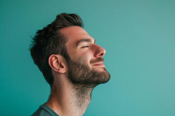 Obraz premium A close up of a man with beard and closed eyes looking to a side