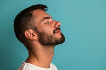 Fototapeta premium A close up of a man with beard and closed eyes looking to a side
