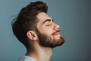Fototapeta premium A close up of a man with beard and closed eyes looking to a side