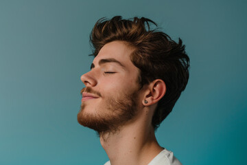 Obraz premium A close up of a man with beard and closed eyes looking to a side