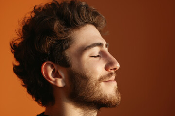 Fototapeta premium A close up of a man with beard and closed eyes looking to a side