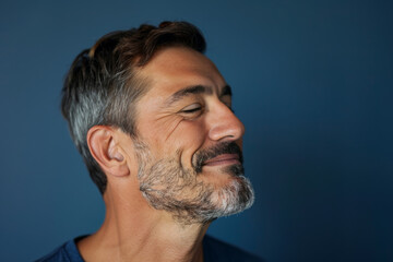 Fototapeta premium A close up of a man with beard and closed eyes looking to a side