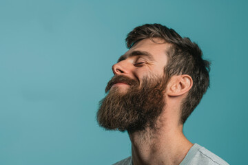 Obraz premium A close up of a man with beard and closed eyes looking to a side