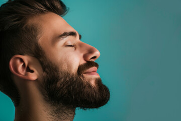Fototapeta premium A close up of a man with beard and closed eyes looking to a side