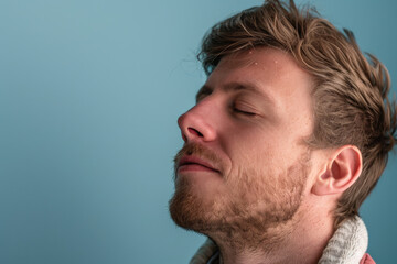 Obraz premium A close up of a man with beard and closed eyes looking to a side