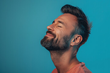 Obraz premium A close up of a man with beard and closed eyes looking to a side