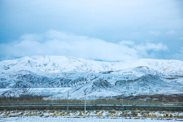 Haixi Mongolian and Tibetan Autonomous Prefecture, Qinghai Province - Meadow Road under Snowy...