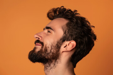 Fototapeta premium A close up of a man with beard and closed eyes looking to a side