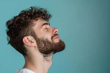 Fototapeta premium A close up of a man with beard and closed eyes looking to a side