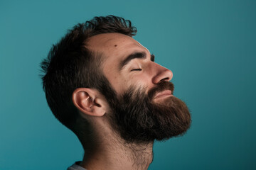 Obraz premium A close up of a man with beard and closed eyes looking to a side
