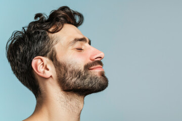 Obraz premium A close up of a man with beard and closed eyes looking to a side