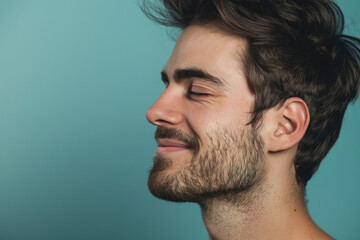 Fototapeta premium A close up of a man with beard and closed eyes looking to a side