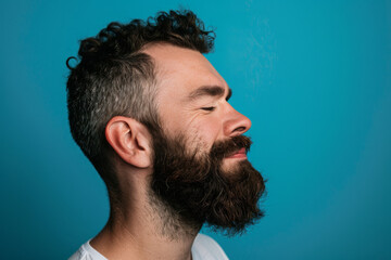 Fototapeta premium A close up of a man with beard and closed eyes looking to a side