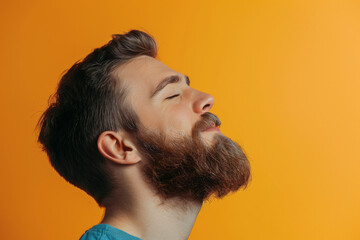 Obraz premium A close up of a man with beard and closed eyes looking to a side