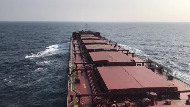 A merchant ship underway at sea, view of deck from bridge