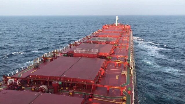 A merchant ship underway at sea, view of deck from bridge