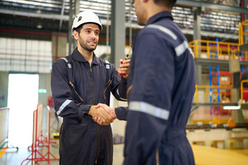 Engineers or technicians shaking hands before starting work at train construction site