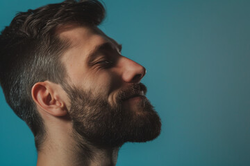 Fototapeta premium A close up of a man with beard and closed eyes looking to a side