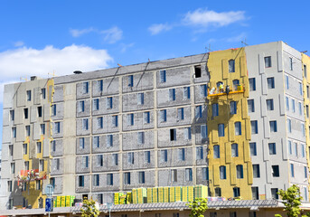 Facade Insulation. Suspended cradle mobile scaffolding platform for construction work at height....