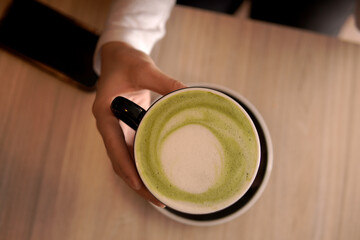 hand top view with matcha cup