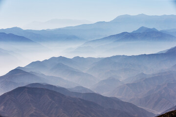 The Andes Mountains shrouded in fog create a mystical and ethereal atmosphere. As the mist weaves...