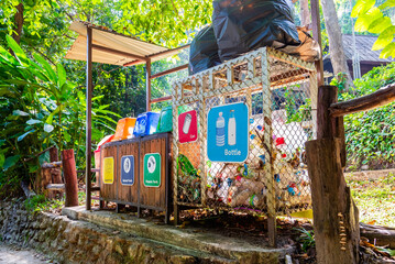 Obraz premium Sorting garbage bin by material and type.Recycle trash bin with sorted garbage vector icons at nature park for environmental protection, ecology. for environmental protection, ecology.