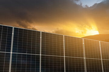 Solar panels on a background of dramatic sunset sky.