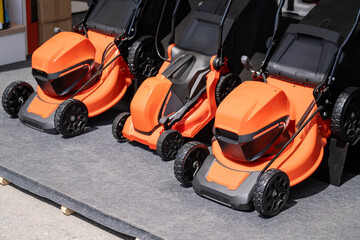 Fototapeta premium Electric lawn mowers in a row.