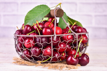 Fresh cherries in a basket on a light background.Close-up.
