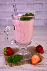 Strawberry banana smoothie in a tall glass. Close-up.

