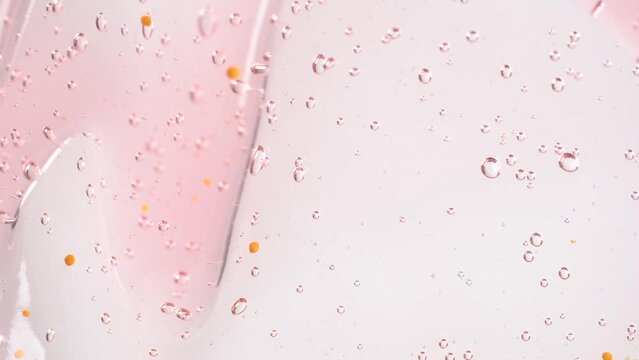 Macro shot of intensive bubbles in peach fuzz color inside it shower gel.