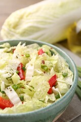 Tasty salad with Chinese cabbage in bowl on table, closeup