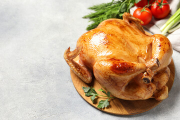 Tasty roasted chicken with parsley on light grey table, space for text
