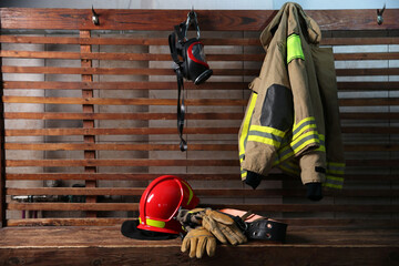 Firefighter`s uniform, helmet, gloves and mask at station