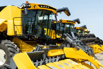 Row of agricultural combines for sale.