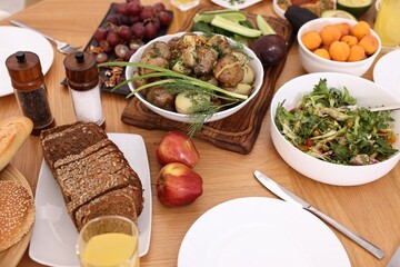 Healthy vegetarian food and glass of juice on wooden table