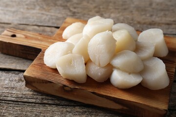 Fresh raw scallops on wooden table, closeup