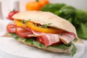Tasty sandwich with bacon and bell pepper on white table, closeup
