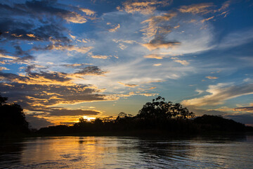 A sunset over the Amazonian jungle is a breathtaking spectacle of nature, offering a mesmerizing...
