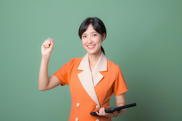 Woman in orange dress holding stylus and tablet
