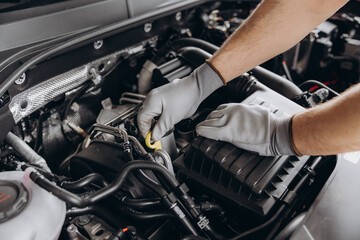 Troubleshooting process. Auto mechanic working in garage. Repair service.