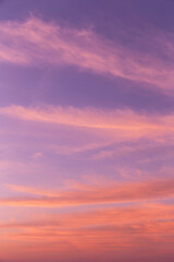 Dramatic soft sunrise, sunset pink violet orange sky with cirrus clouds background texture