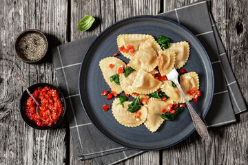 italian pasta mezzelune on a plate, top view