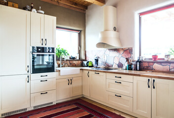 Interior of kitchen in vintage rustic style with wooden furniture in a cottage