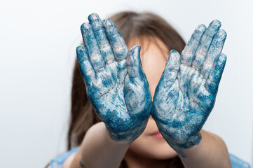 Blue painted kid hands