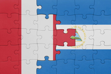 puzzle with the colourful national flag of nicaragua and flag of peru .