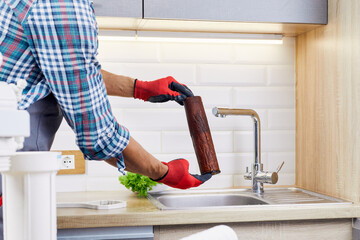 Plumber installs or change water filter. Replacement aqua filter. Repairman installing water filter...