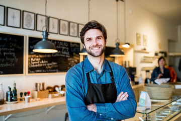 Man in small business, working in his own bistro. Young male business owner.