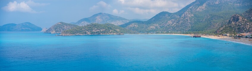 Aerial view of Oludeniz beach with people and boats in the morning, Coastline next to Fethiye,...
